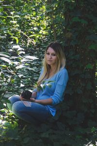 Portrait of young woman sitting outdoors