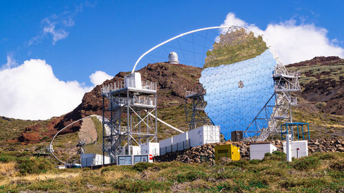 Built structure on field against sky