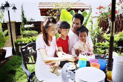 Family celebrating birthday in lawn