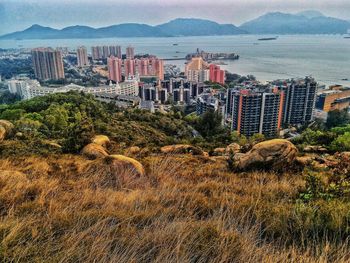 Scenic view of sea and buildings in city