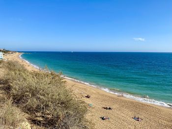 Scenic view of beach against blue sky