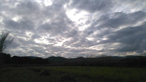 Scenic view of landscape against cloudy sky