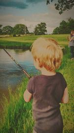 Rear view of boy in lake