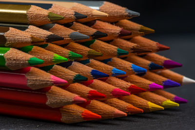 Close-up of multi colored pencils on table