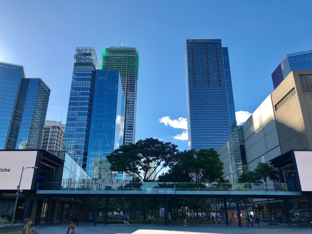 BUILDINGS BY SWIMMING POOL AGAINST SKY