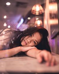 Portrait of young woman lying down on floor