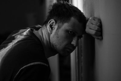 Close-up of young man standing at home