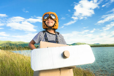 Low angle view of young man wearing sunglasses against sky