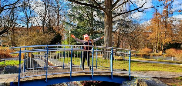 Man standing by railing in park