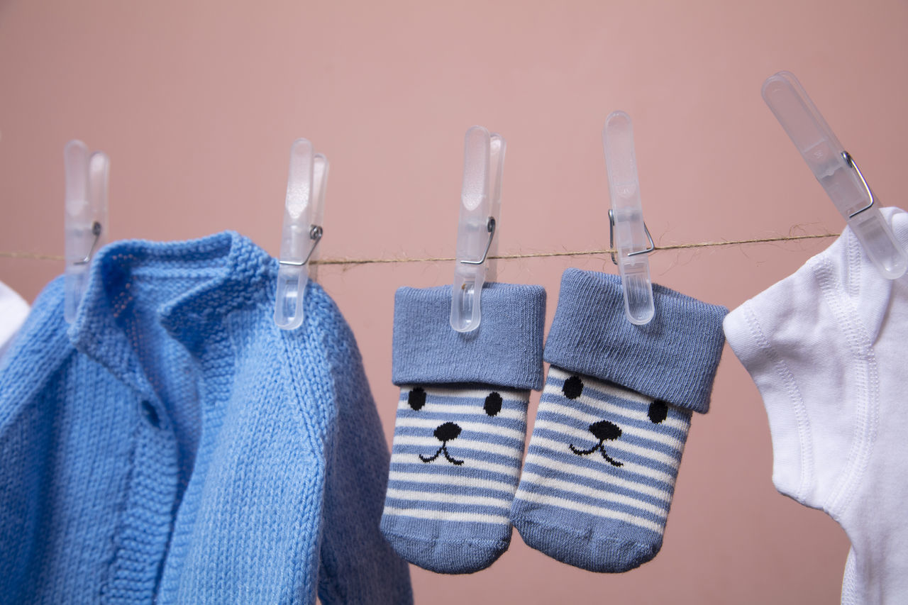 CLOSE-UP OF CLOTHES HANGING ON WALL