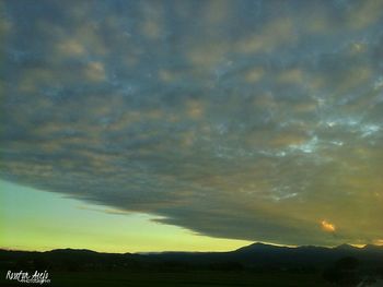 Scenic view of silhouette landscape against sky at sunset