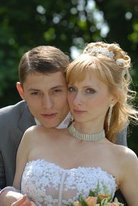 Portrait of newlywed couple standing in park