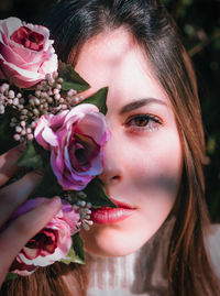 Close-up of woman with pink roses