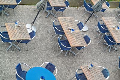 High angle view of empty chairs and tables at beach