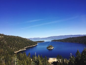 Scenic view of lake against clear blue sky