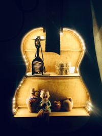 Close-up of electric lamp on wall at home