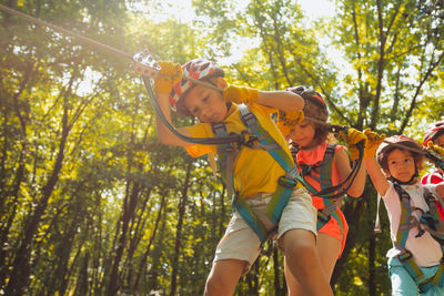 Low angle view of woman standing in forest