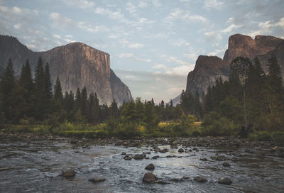 Scenic view of river and mountains against sky