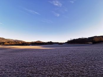 Scenic view of lake against blue sky