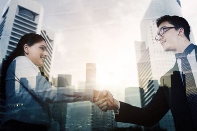 Young couple looking at office buildings in city