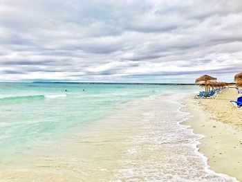 View of beach against cloudy sky