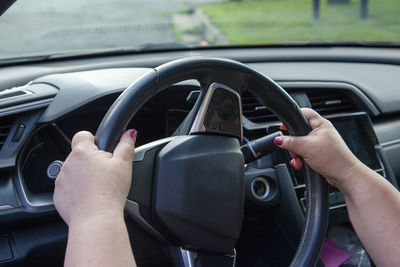 Cropped image of hand on car