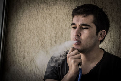 Portrait of young man smoking