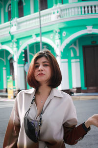 Portrait of beautiful young woman standing outdoors