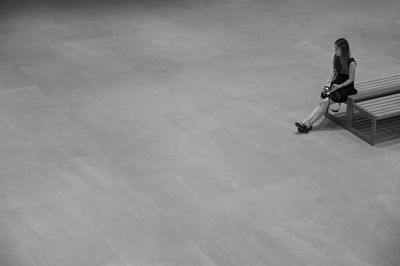 High angle view of woman sitting on floor