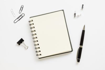 High angle view of pen on paper against white background