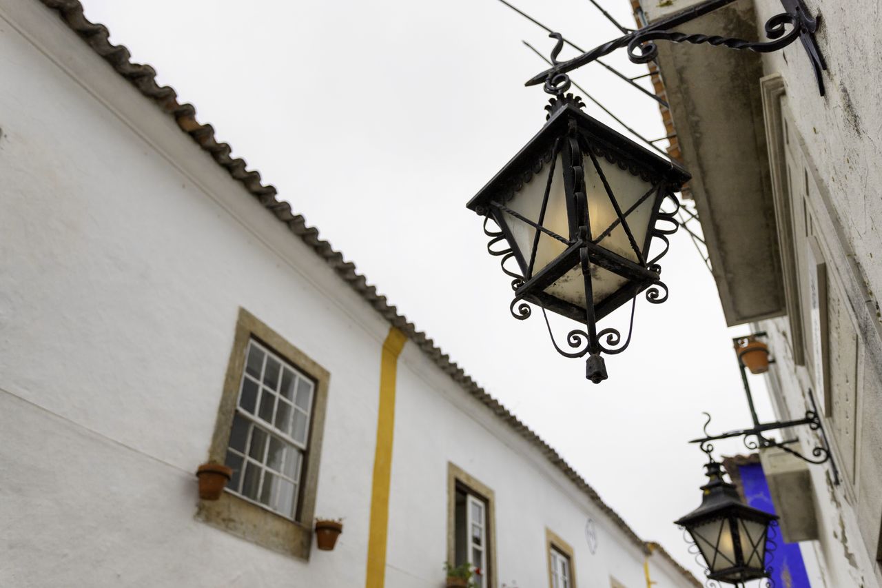 LOW ANGLE VIEW OF LANTERN HANGING ON BUILDING