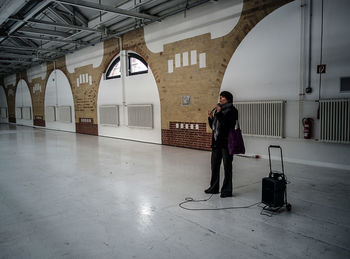 Full length of woman standing in tunnel