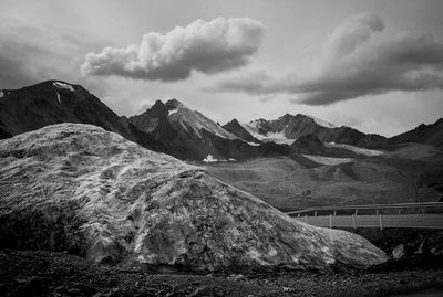 Scenic view of mountains against cloudy sky