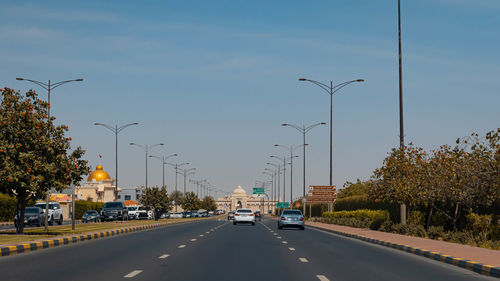 Cars on road against sky