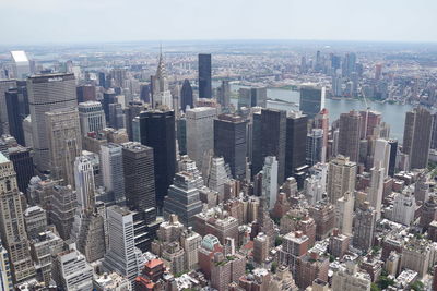 Aerial view of modern buildings in city against sky