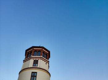 Low angle view of building against clear blue sky