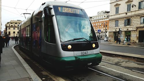 Train on railroad tracks in city