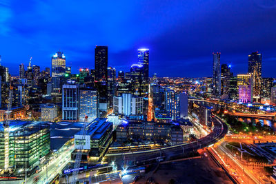 High angle view of illuminated buildings against sky at night