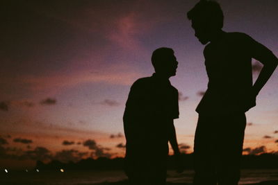 Silhouette men against sky at night