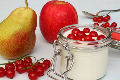 Close-up of strawberries in glass jar on table