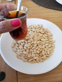 High angle view of hand holding drink on table