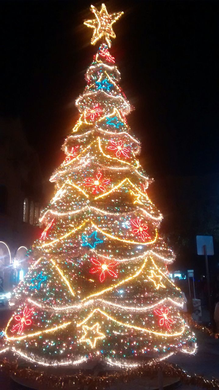 illuminated, night, decoration, celebration, christmas, christmas decoration, multi colored, low angle view, christmas tree, christmas lights, tradition, lighting equipment, cultures, architecture, building exterior, built structure, glowing, light - natural phenomenon, celebration event, traditional festival