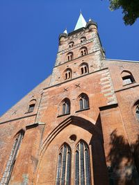 Low angle view of historic building against clear blue sky