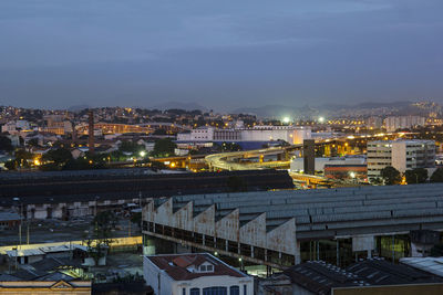 High angle view of illuminated town against sky at night