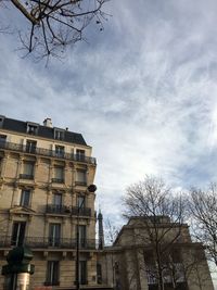 Low angle view of building against cloudy sky