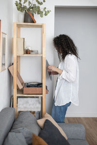 Rear view of woman standing at home