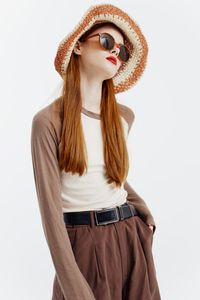 Young woman wearing hat against white background