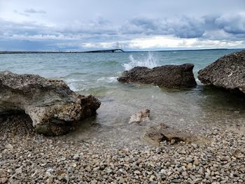 Rocks on beach against sky