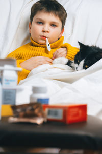 Portrait of boy lying on bed