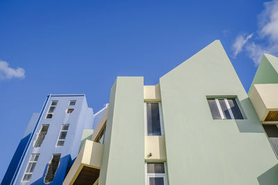 Low angle view of modern building against clear blue sky